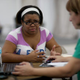 Wendy Gonzalez sits with, Maria Mena, an insurance agent from Sunshine Life and Health Advisors as she purchases insurance under the Affordable Care Act at a store setup in the Mall of Americas on March 20, 2014 in Miami, Florida.
Photo by Joe Raedle/Getty Images